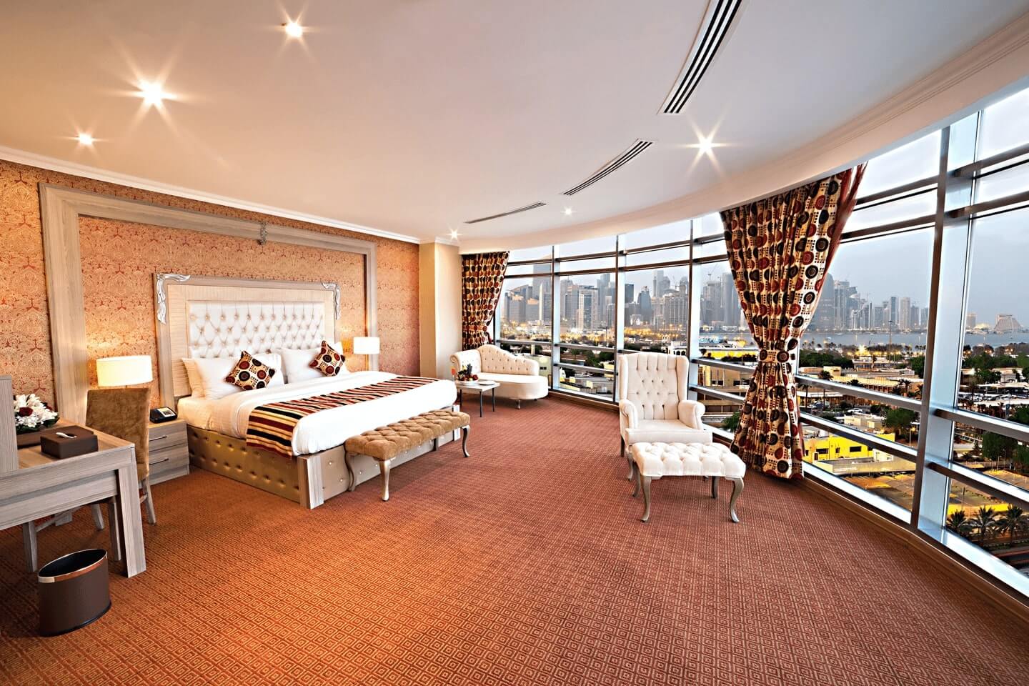 Spacious Diplomatic Suite interior at Sapphire Plaza Hotel Doha featuring premium bedding, elegant seating area, and large windows in Bin Mahmoud.